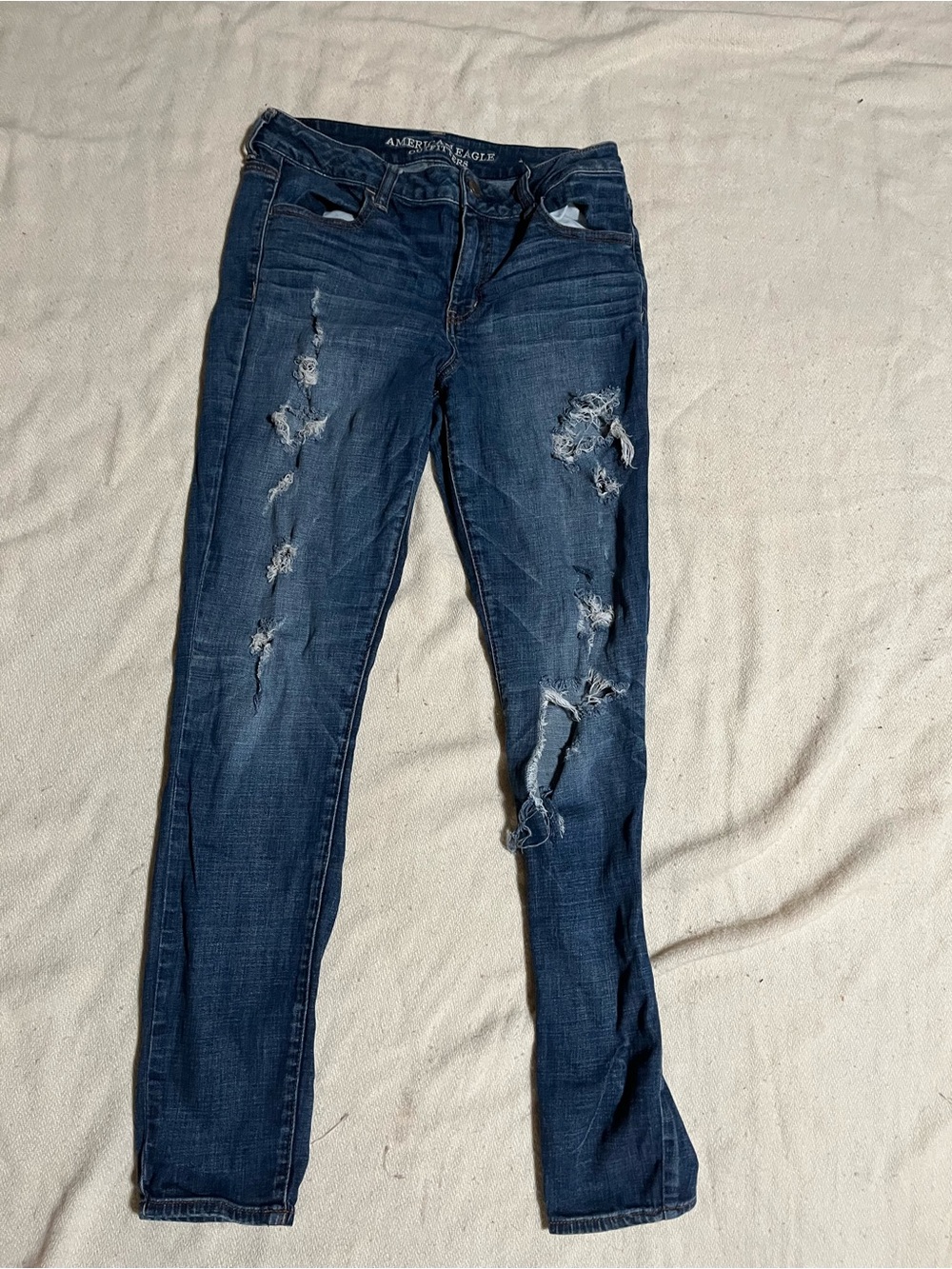 Vintage American Eagle Outfitters Women's Dark Blue Distressed Skinny Jeans.